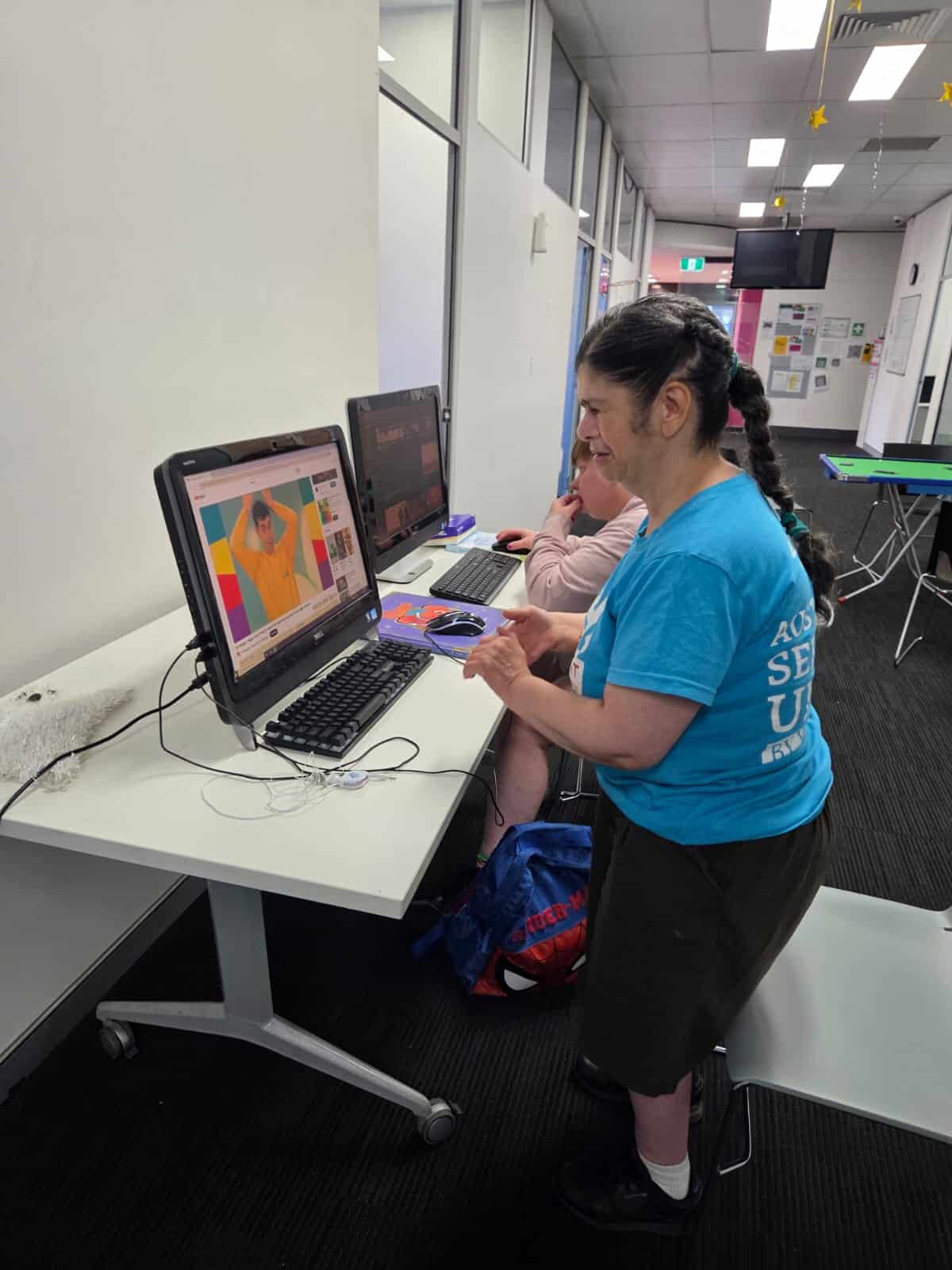 Participants enjoying computer-based activities at Wenty Social Hub