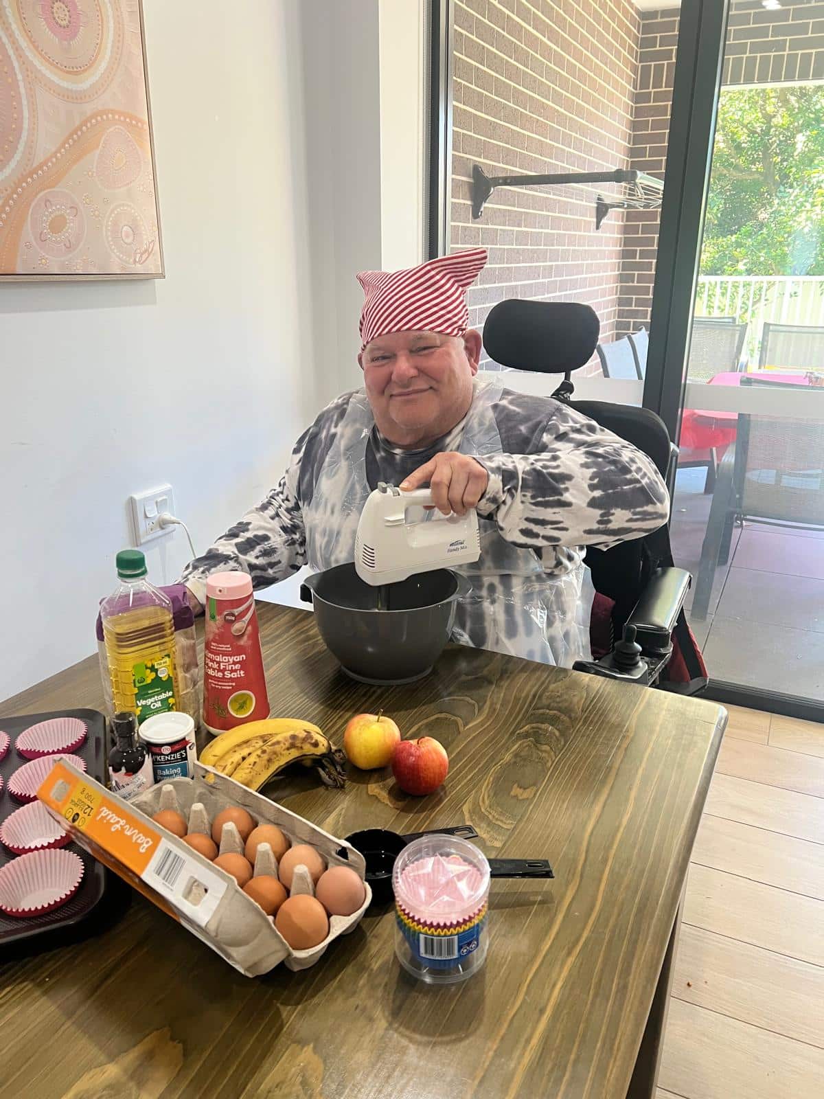 Gary preparing banana cupcakes in the kitchen with Beyond Care