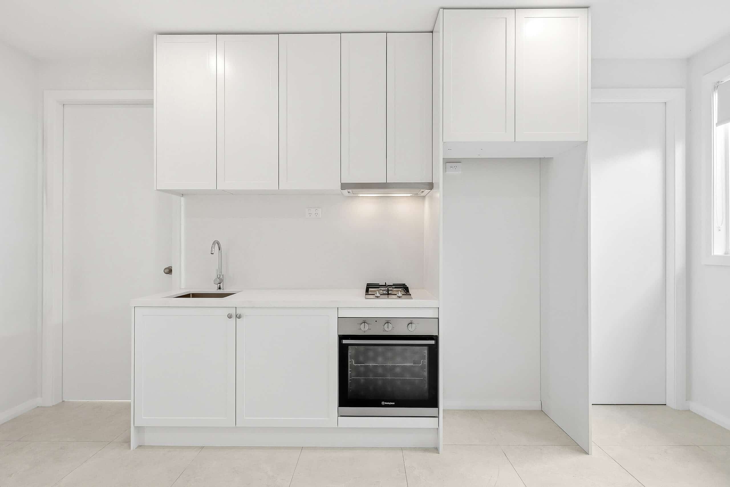 Functional kitchenette with oven, cooktop and built-in storage in the Beyond Care Fairfield villa