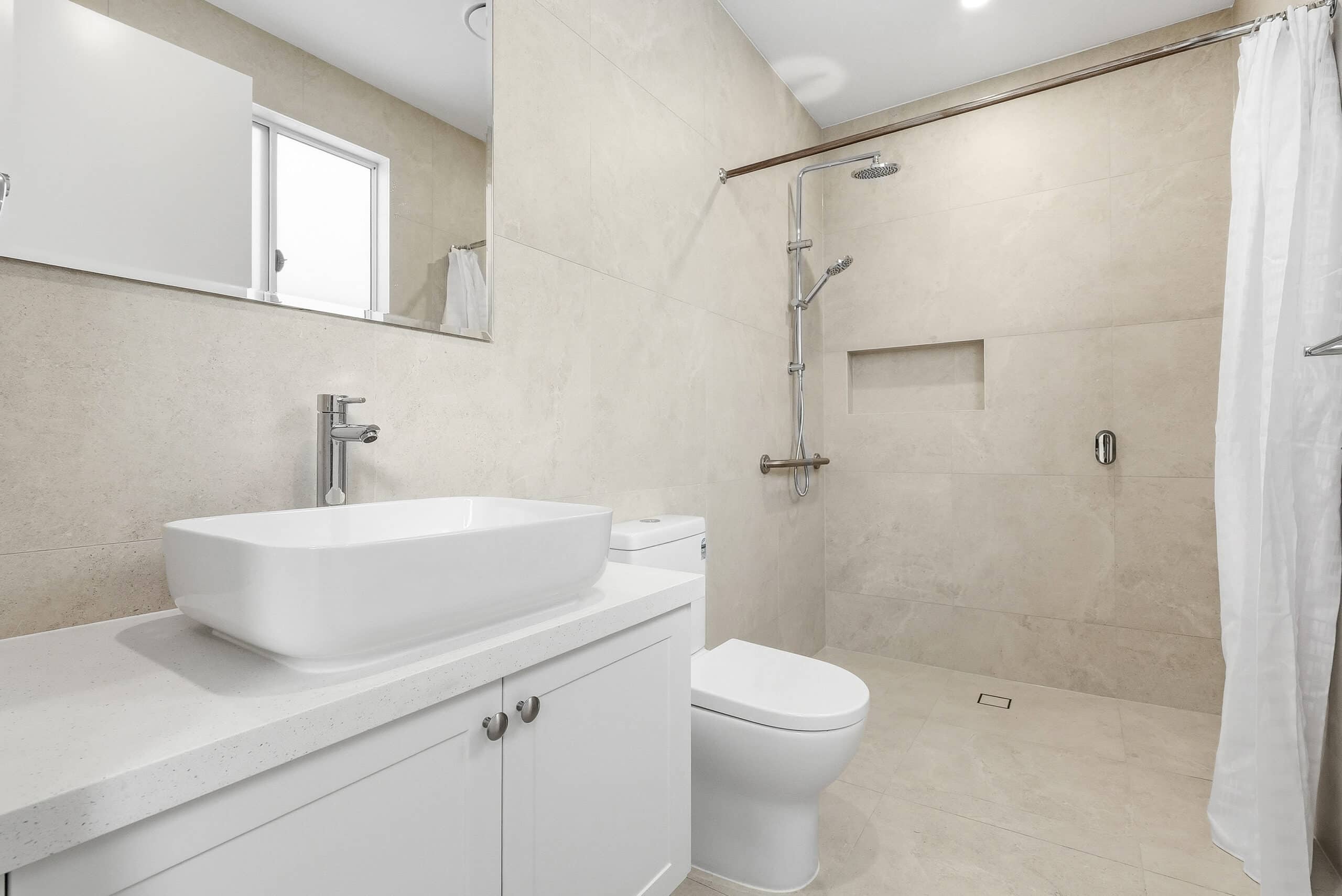 Modern private bathroom with walk-in shower and vanity in the Beyond Care Fairfield villa