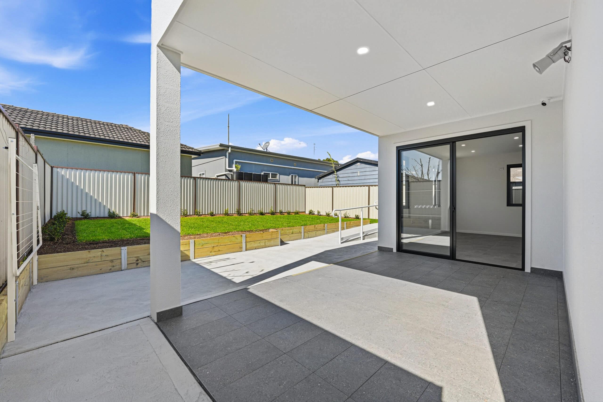 Covered alfresco and outdoor entertaining area looking onto the backyard at the Beyond Care Auburn SDA home