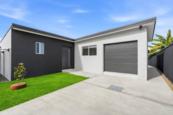 Exterior of the Beyond Care Fairfield West SIL home showing the garage, driveway and lawn