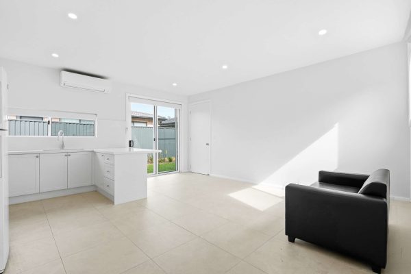 Open living area with kitchen and sliding door to the backyard at the Beyond Care Fairfield West SIL home
