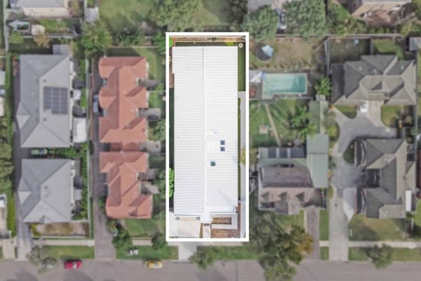 SDA in Penrith 8 Aerial view of a suburban neighborhood with several houses; one house in the center is highlighted by a white border.